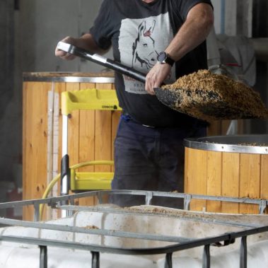 Shovelling out mash tun spent brewers grains